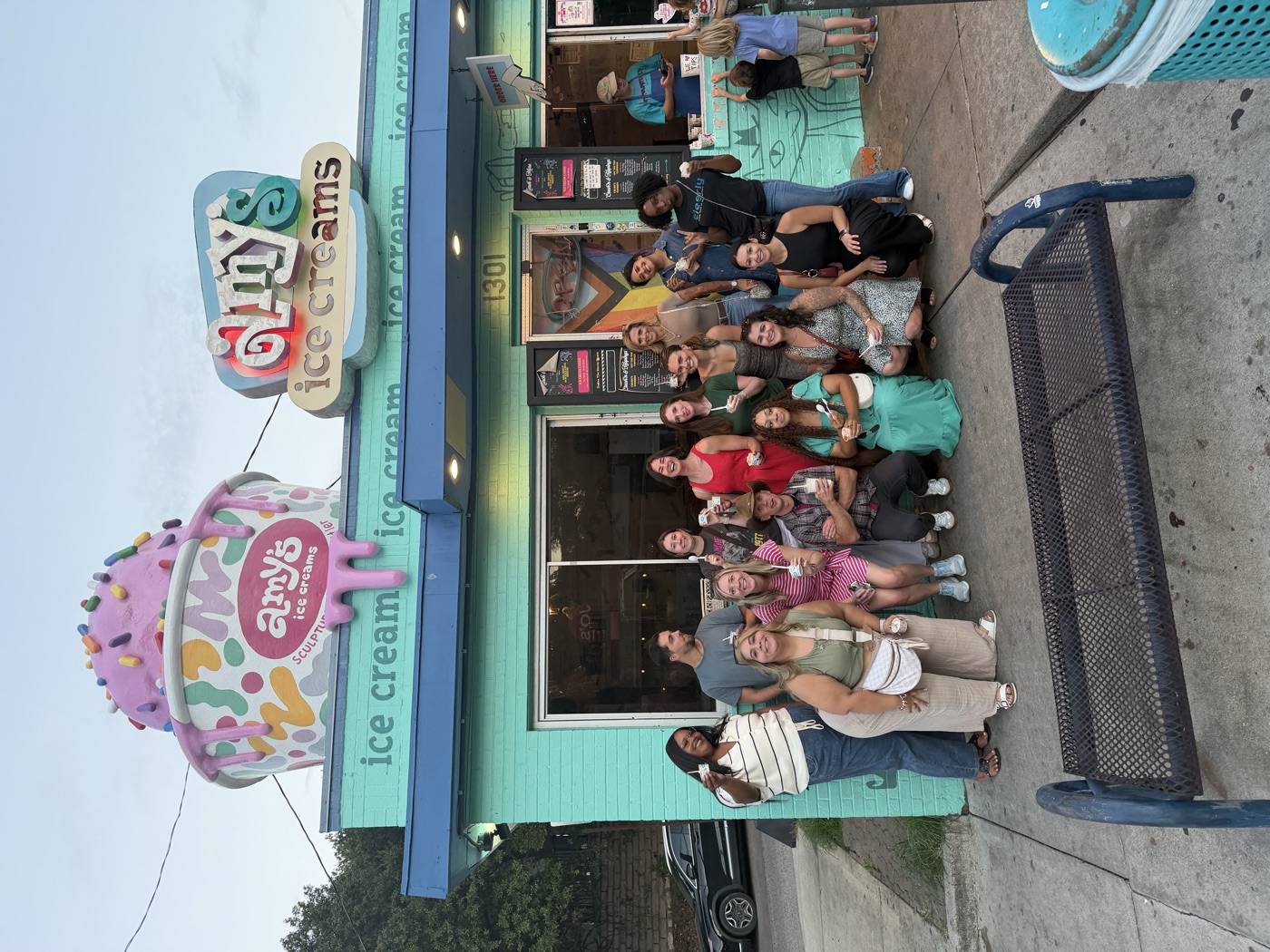 Guests posing with ice cream outside Amy’s Ice Creams on the walking food tour